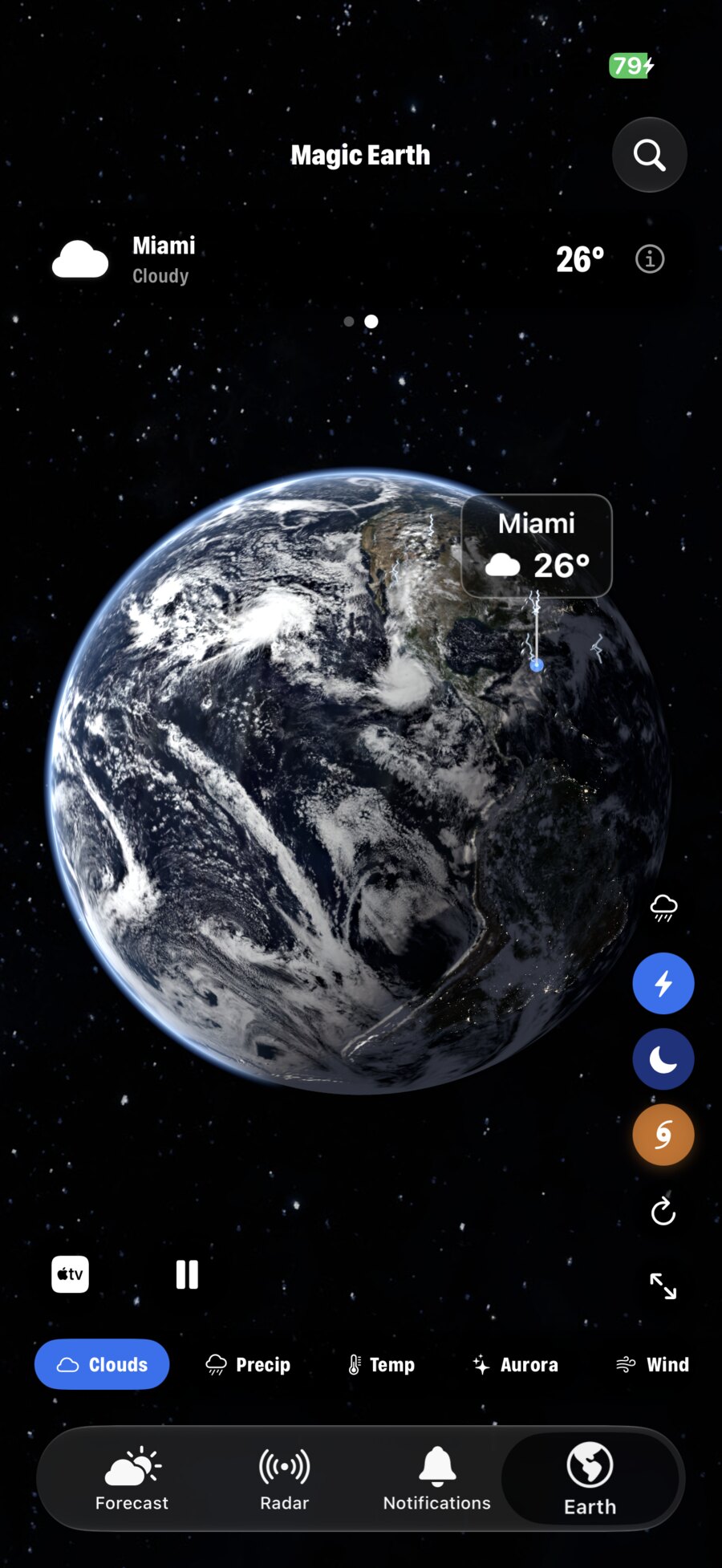 Magic Earth on iPhone: satellite clouds over the Americas with night mode, lightning and storms, and Miami at 26 degrees