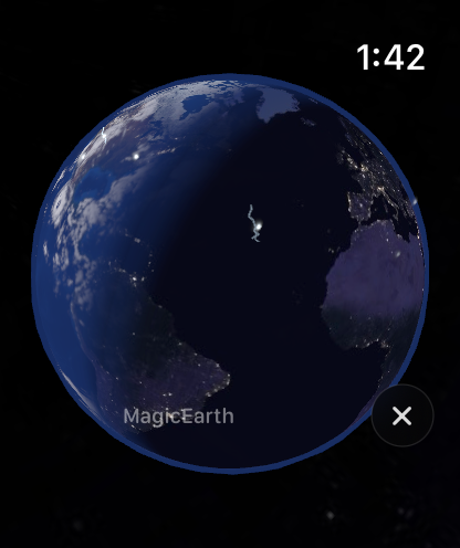 Magic Earth on Apple Watch: the globe at night with city lights and the day side on the horizon
